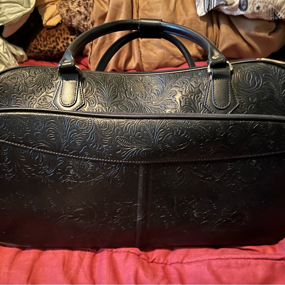 Stylish black with design duffle/carryon bag with wheels! Used